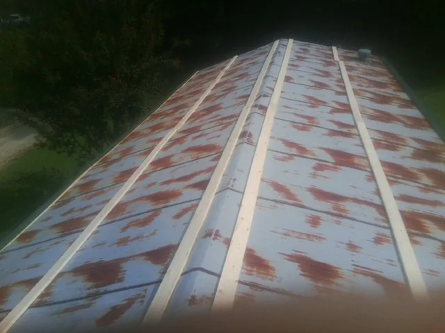 Rusted metal roof panels with new wood purlins before replacement — Storm Damage Roof Repair in Allendale by Roofing Brothers